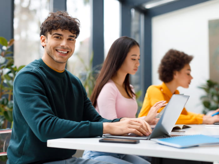 Boy smiling on laptop