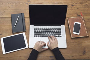 Laptop with other devices at desk