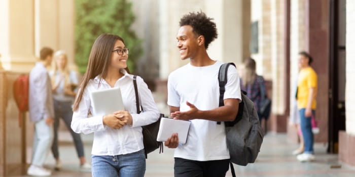 Two students walking through campus