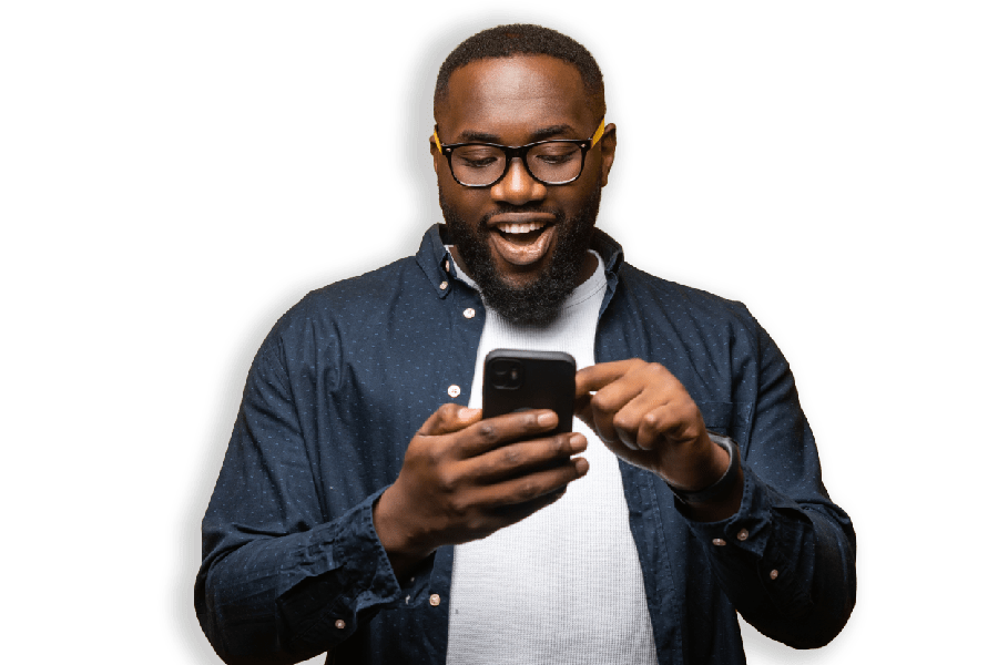 Man smiling as he uses his smartphone