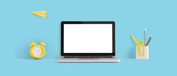 Laptop computer with an alarm clock and stationary beside it