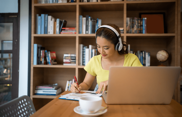 Woman having video call meeting while looking at notes