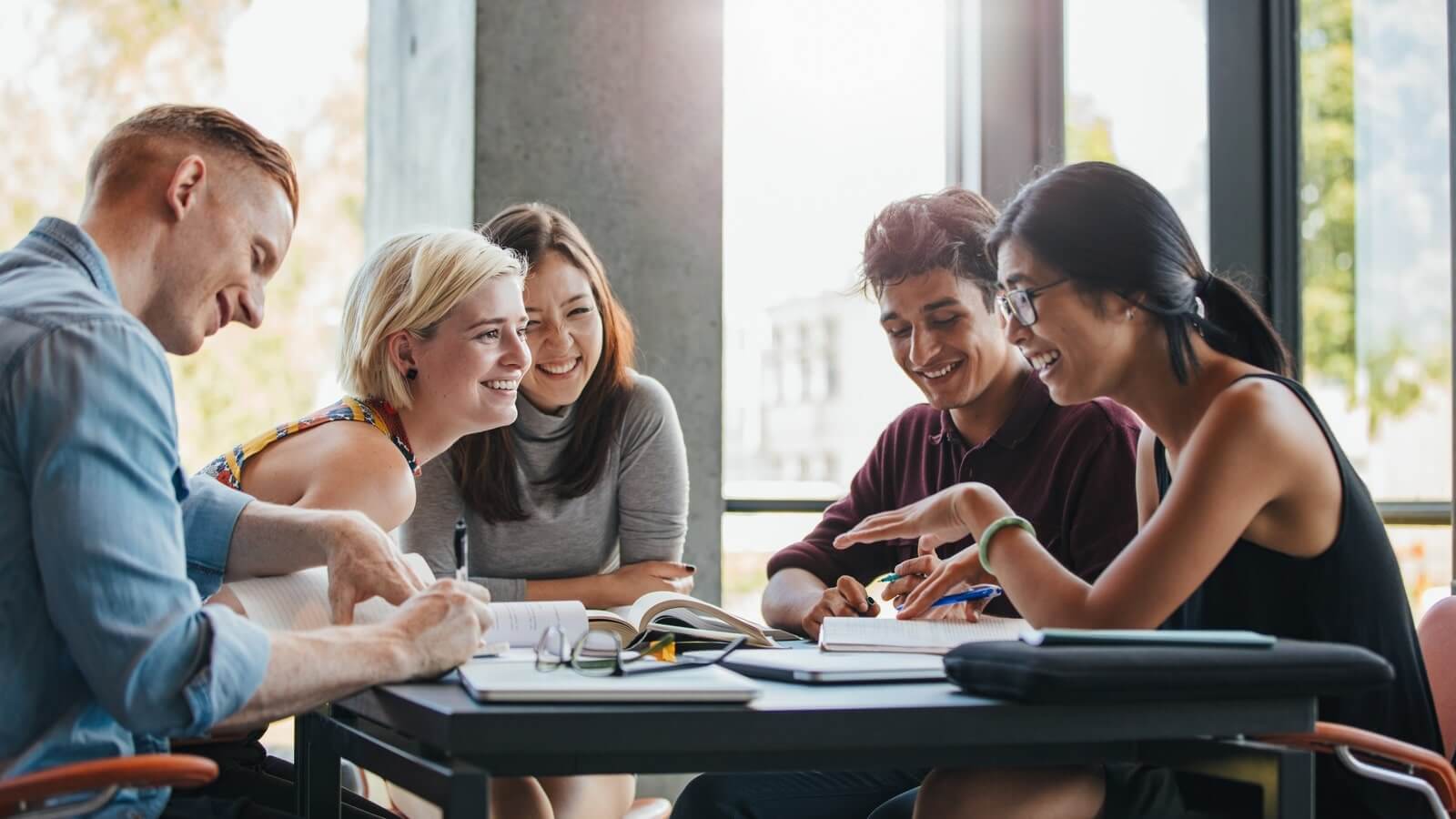 Five students working at a desk
