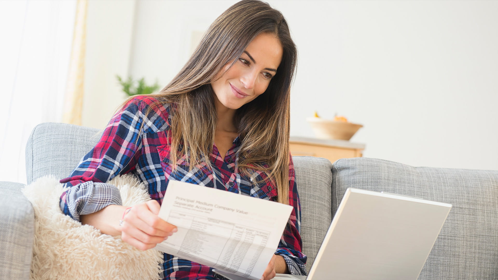 young woman laptop paperwork check shirt personal finance ICAEW students