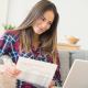 young woman laptop paperwork check shirt personal finance ICAEW students