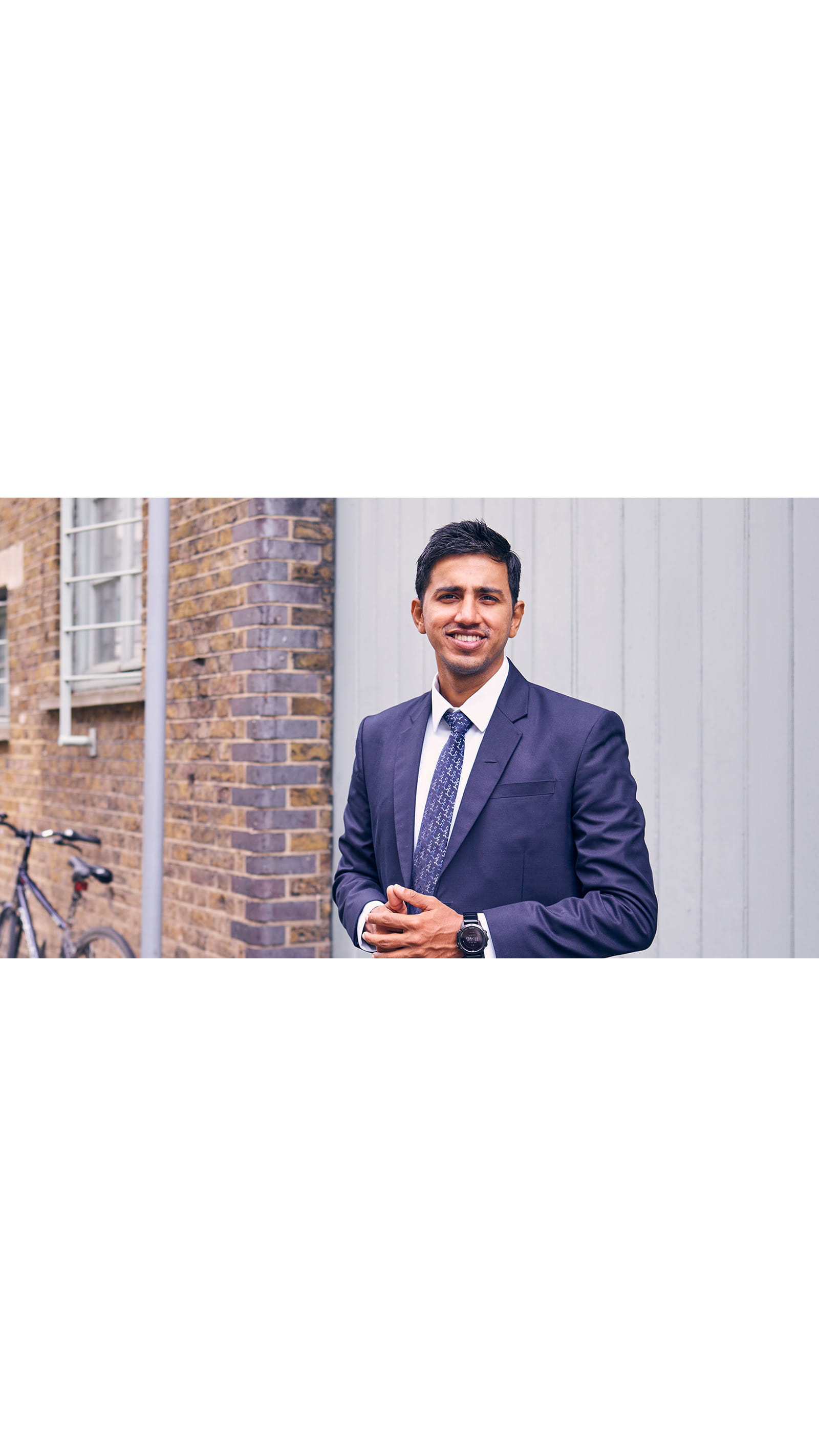 Kamidu Ravindra, accountancy insurance specialist, EY, young Sri Lankan man in a navy suit, London