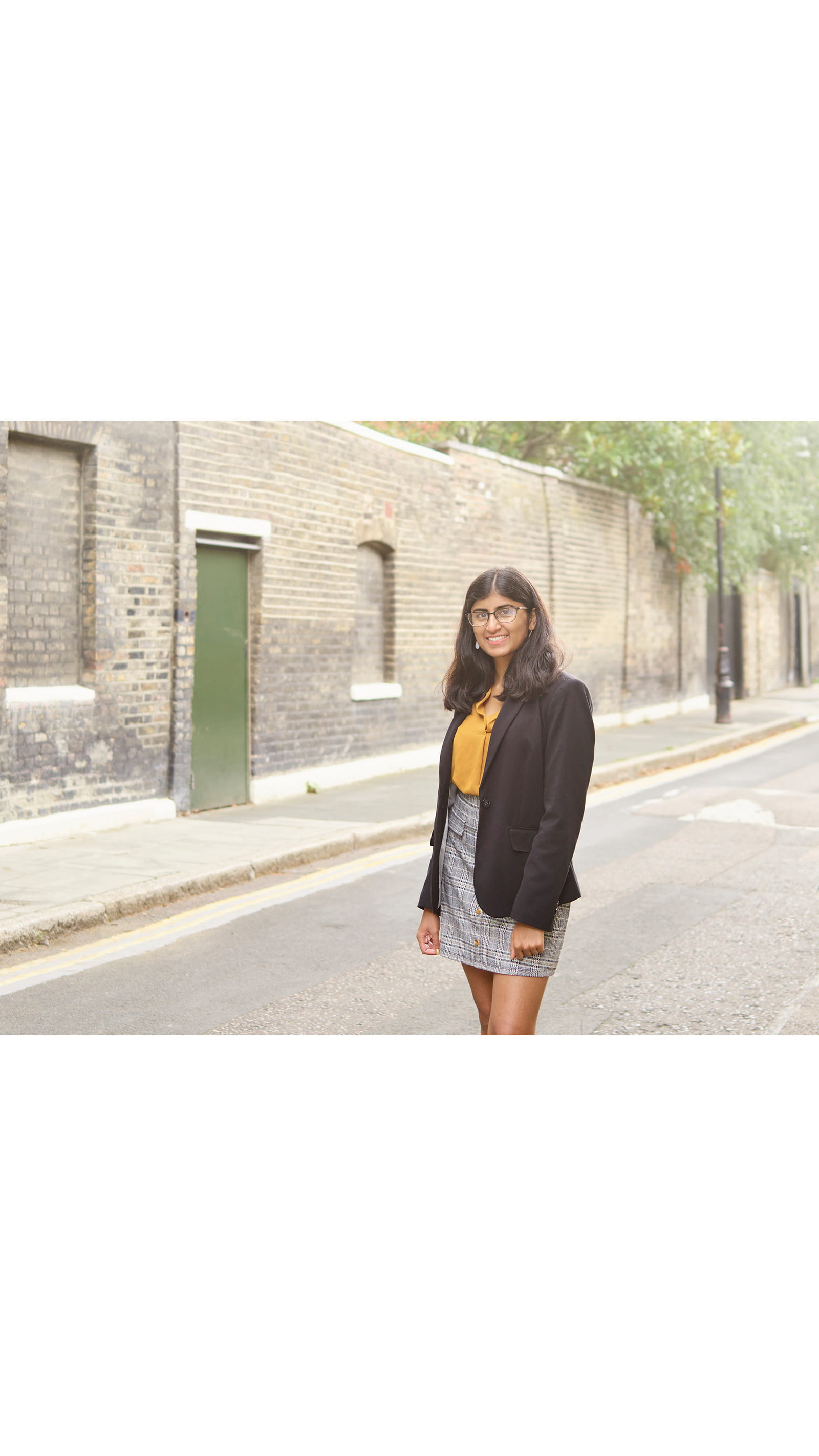 ACA student Ashwini Poopalasingham young asian woman standing in London city street long hair black blazer
