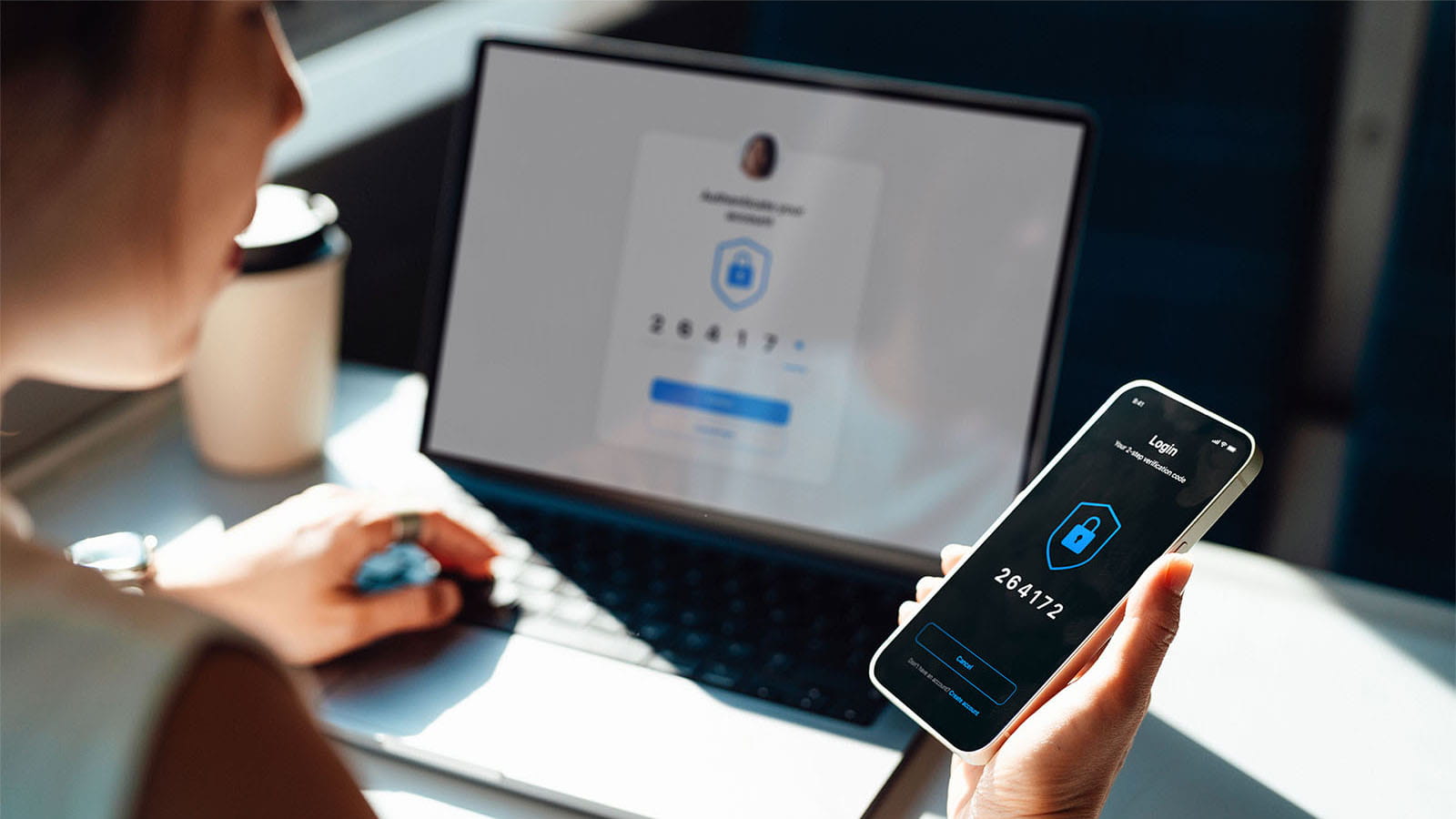 Woman holding and looking at a smart phone and laptop technology cyber security