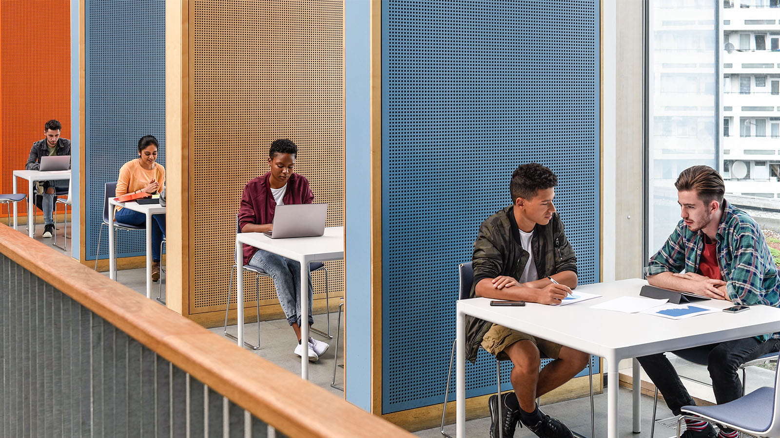 row of students in study area exams cubicles