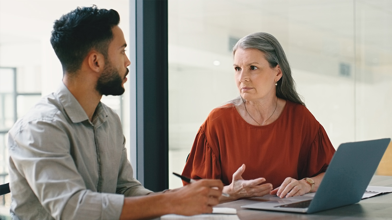 colleagues manager employee having a serious meeting in an office meeting room