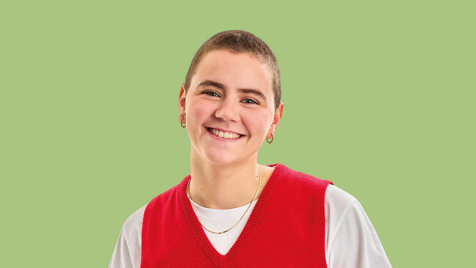 Image of a short haired women with a bright redt tank top and a green background