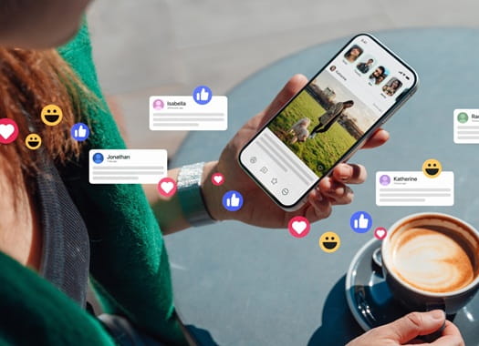 Image of a person looking at social media updates on their phone with a cup of coffee