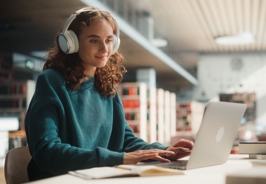 Woman on laptop wearing headphones