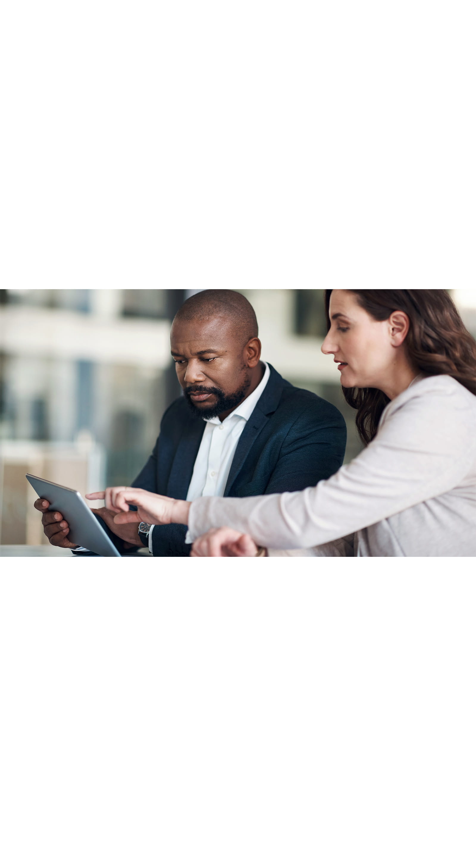 employees colleagues man woman office company looking pointing at touching ipad tablet working together