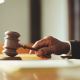 hand judge holding a wooden anvil hammer courtroom law rules