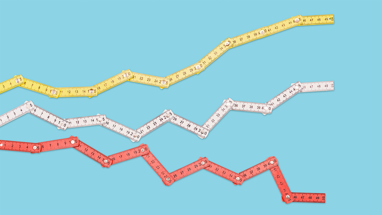 three folding rulers representing line graphs charts in yellow white red