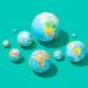 group of globes balls earth multicoloured maps on a teal background