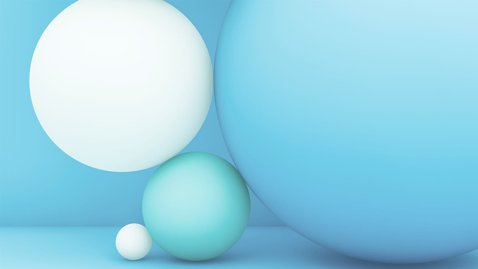 digital illustration of circular spheres large and small blue teal white