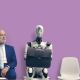 Man and robot sat down waiting in interview queue