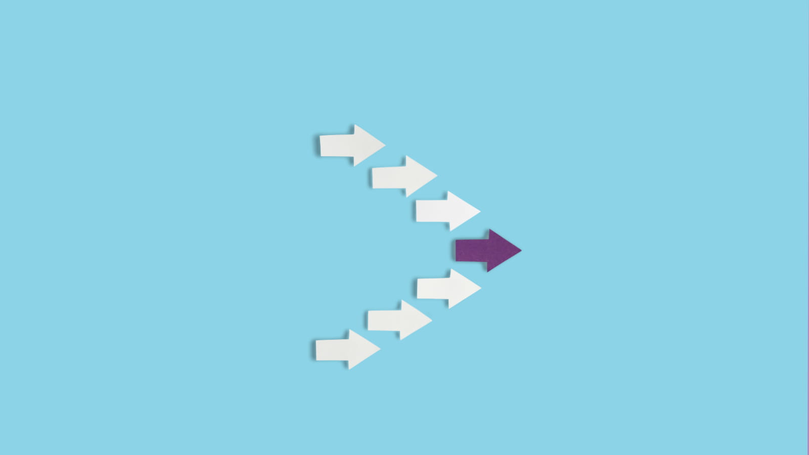 arrows pointing to the right on a blue background where the middle arrow is purple