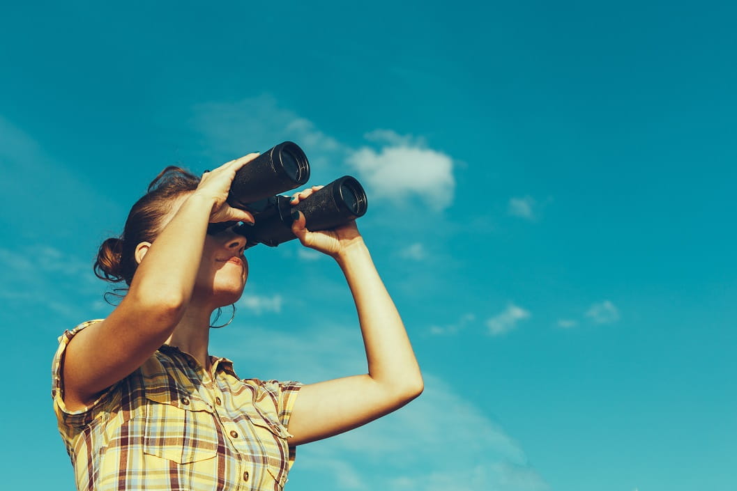 Woman looking through binoculars