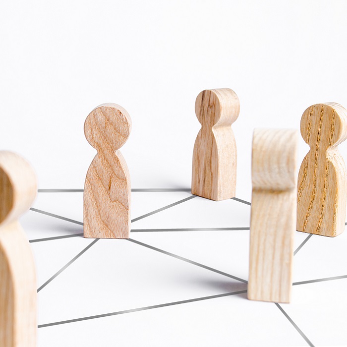 Wooden blocks of people connected by lines