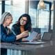 Smiling business women working together on contract documents