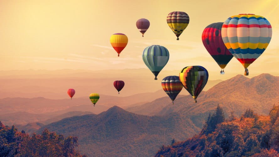 Image of hot air balloons with a mountainous background