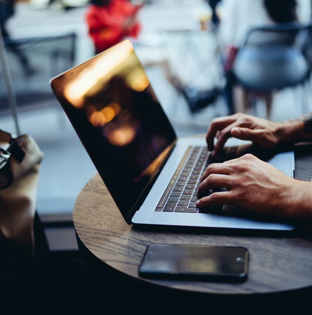 Fingers poised above a laptop keyboard