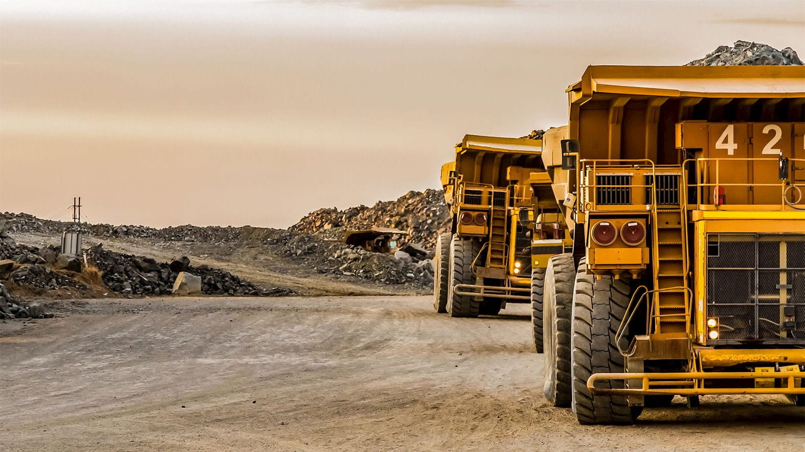 large yellow mining trucks mine trendwatch M&A ICAEW Corporate Financier