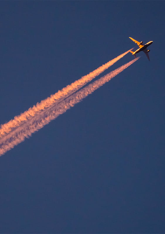 plane dark blue sky jet stream