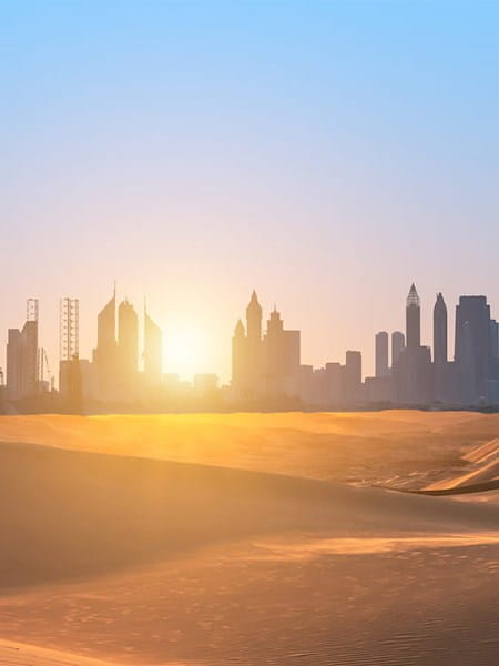 Middle East Dubai city skyline desert sand dunes sunset sunrise blue sky