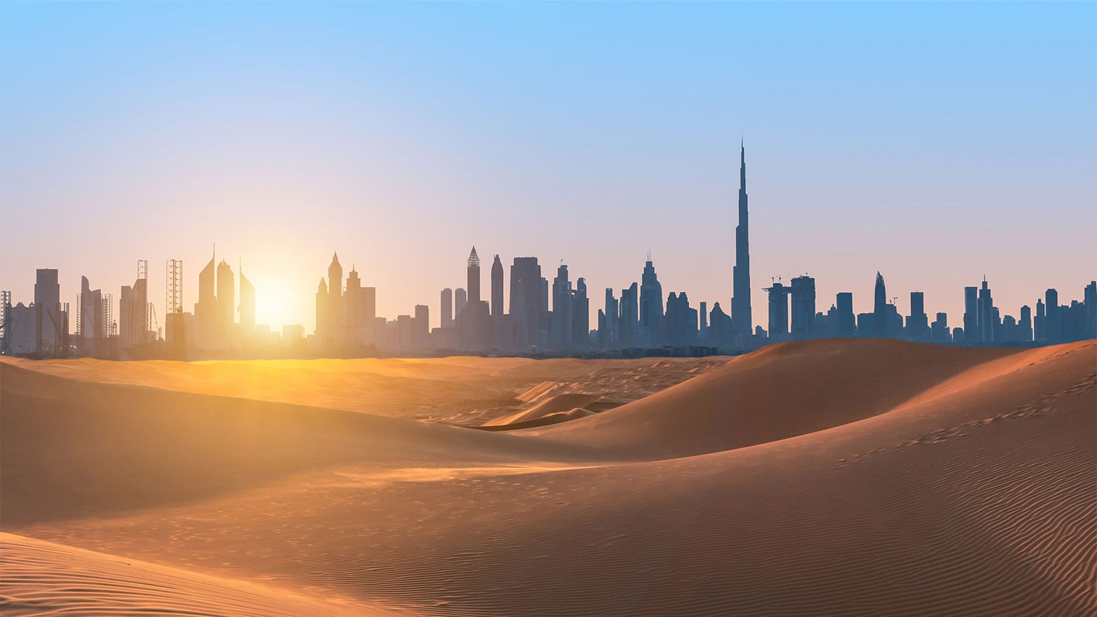 Middle East Dubai city skyline desert sand dunes sunset sunrise blue sky