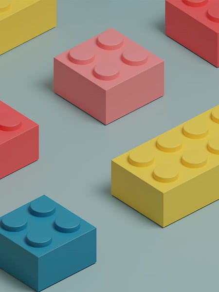 2D illustration lego bricks yellow pink red blue grey background