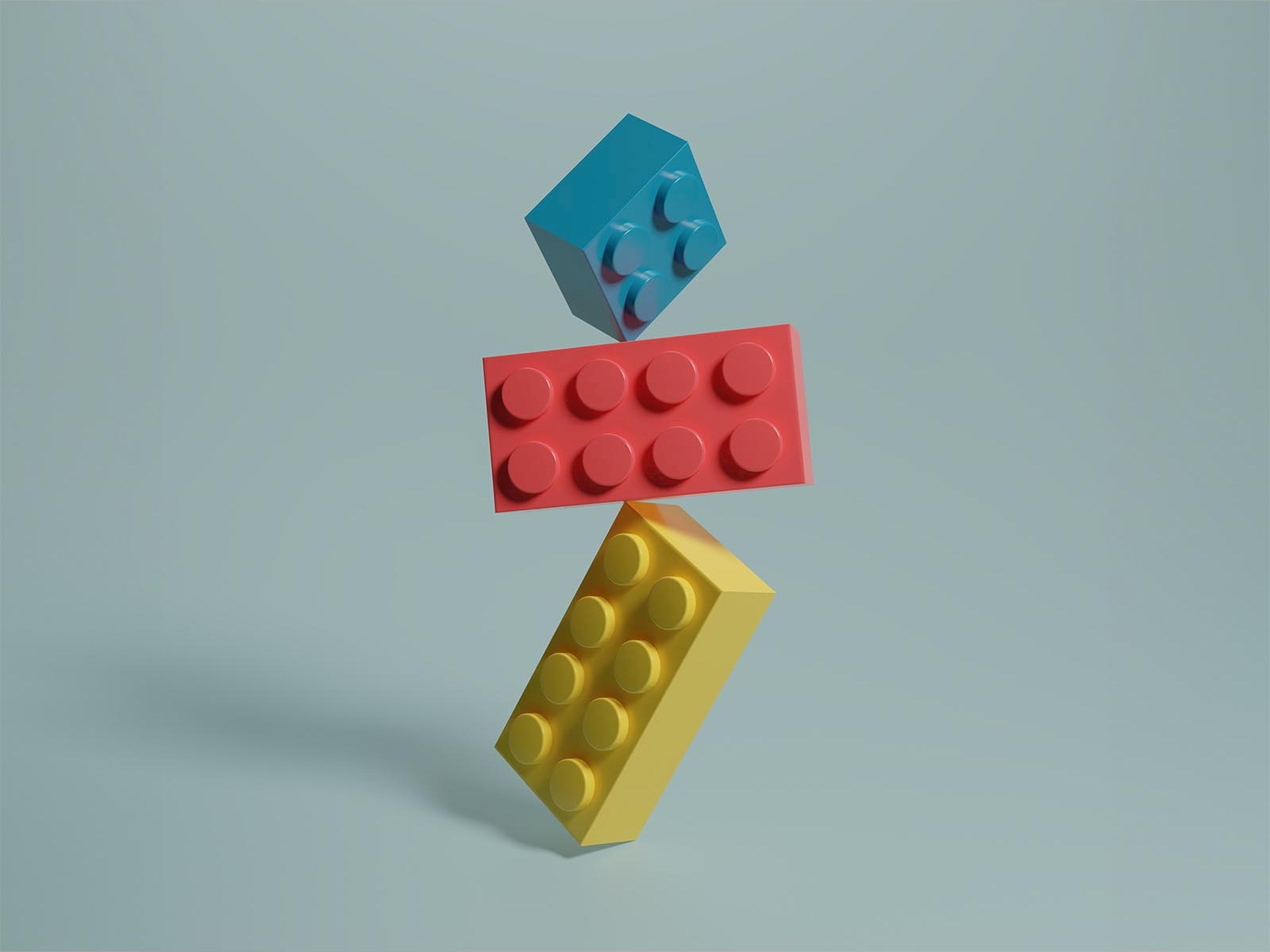 2D illustration lego bricks yellow red blue balancing on one another grey background