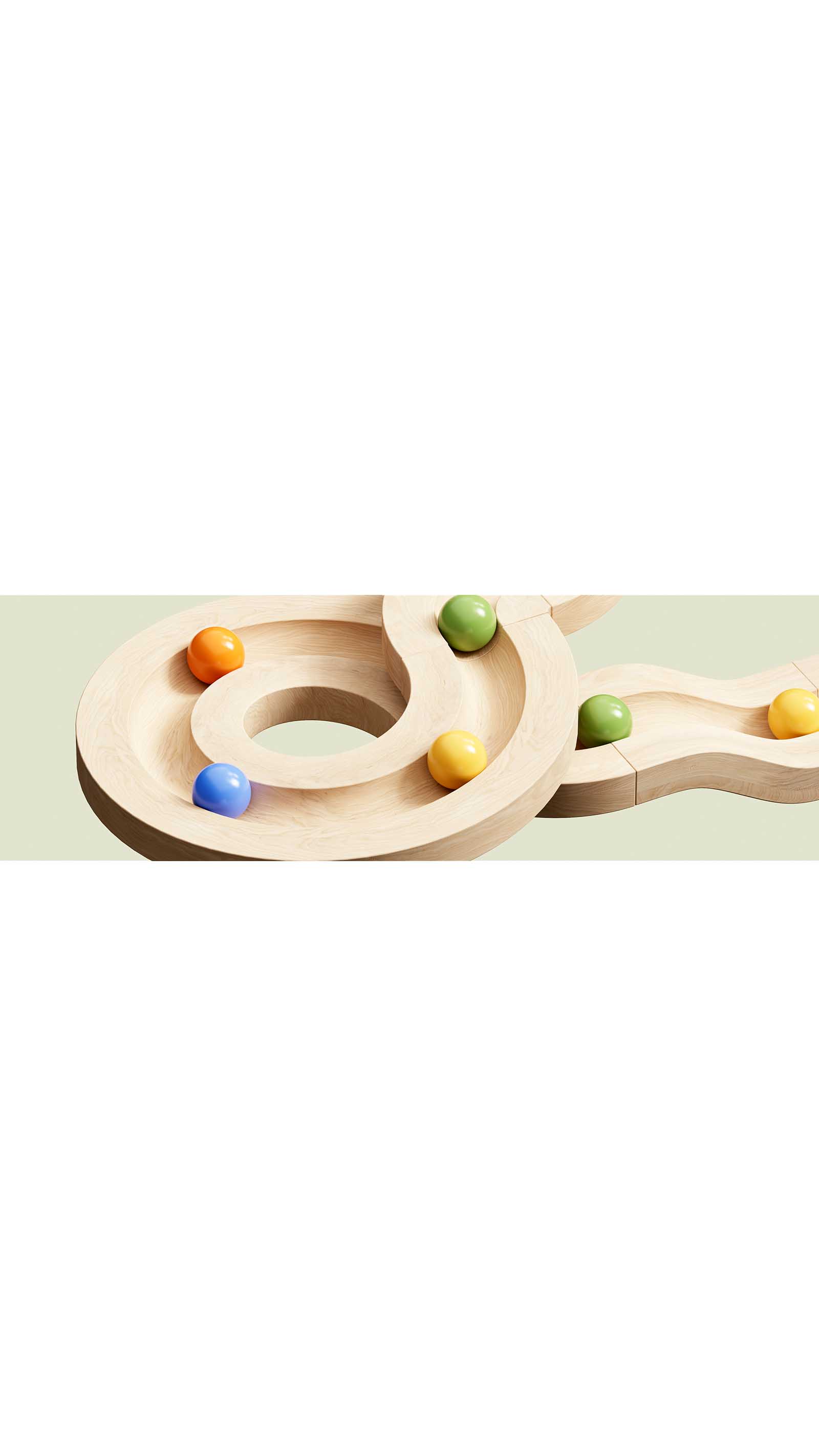 wooden toy colourful marbles racing on track in loops circles green background