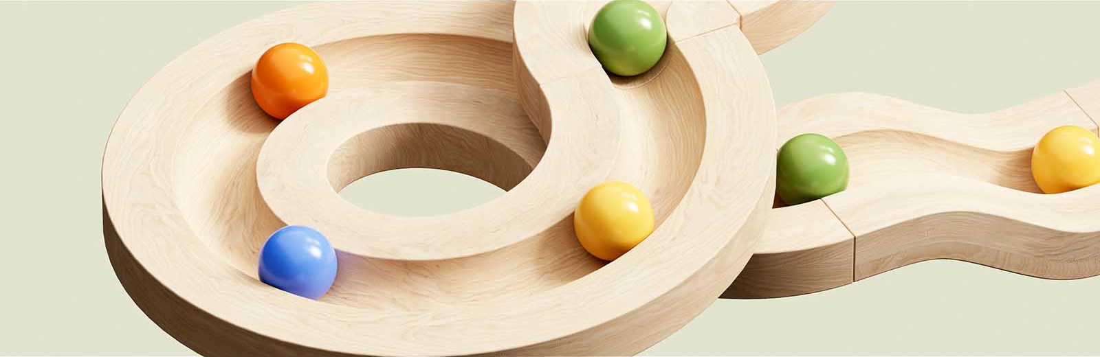 wooden toy colourful marbles racing on track in loops circles green background