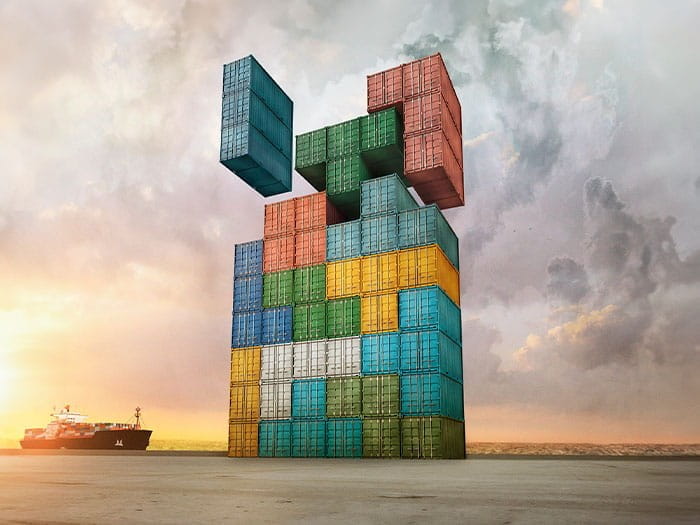 shipping containers stack tower multi colours like Tetris slotting together dock sunset ship clouds