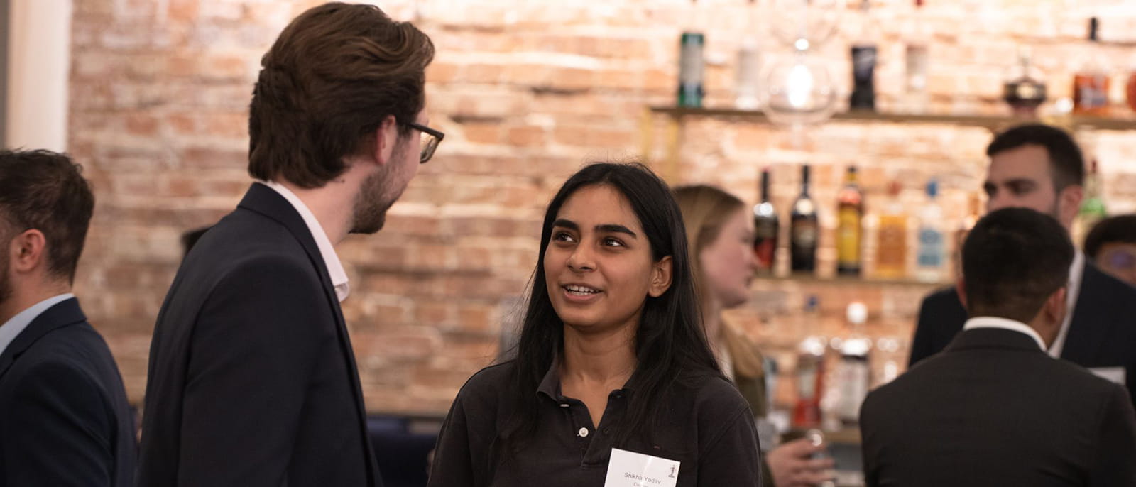 two young people networking talking at an ICAEW event