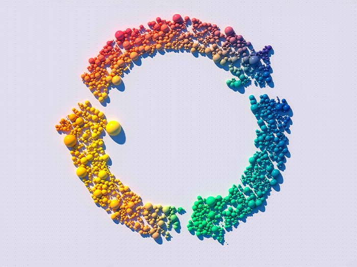 circle or three arrows formed of small colourful rainbow ombre balls