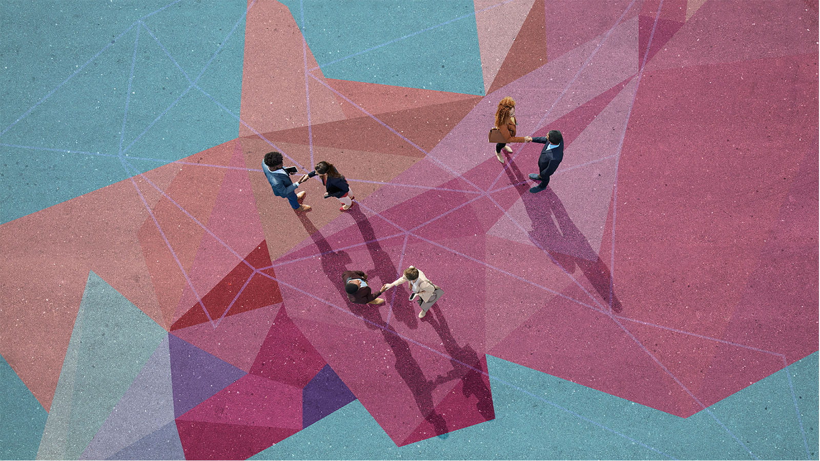 aerial birds eye photo of people meeting shaking hands on a painted geometric floor