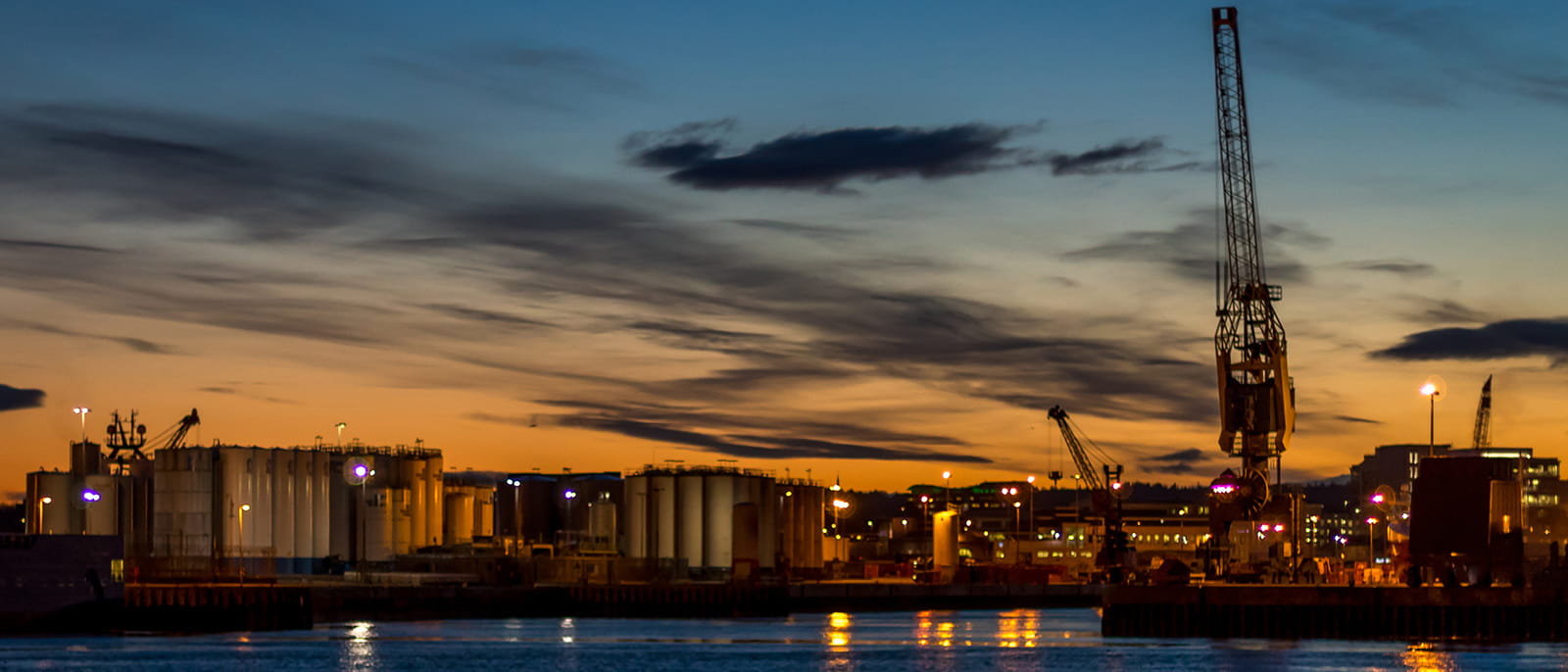 Aberdeen Scotland city harbour crane river water sunset orange sky