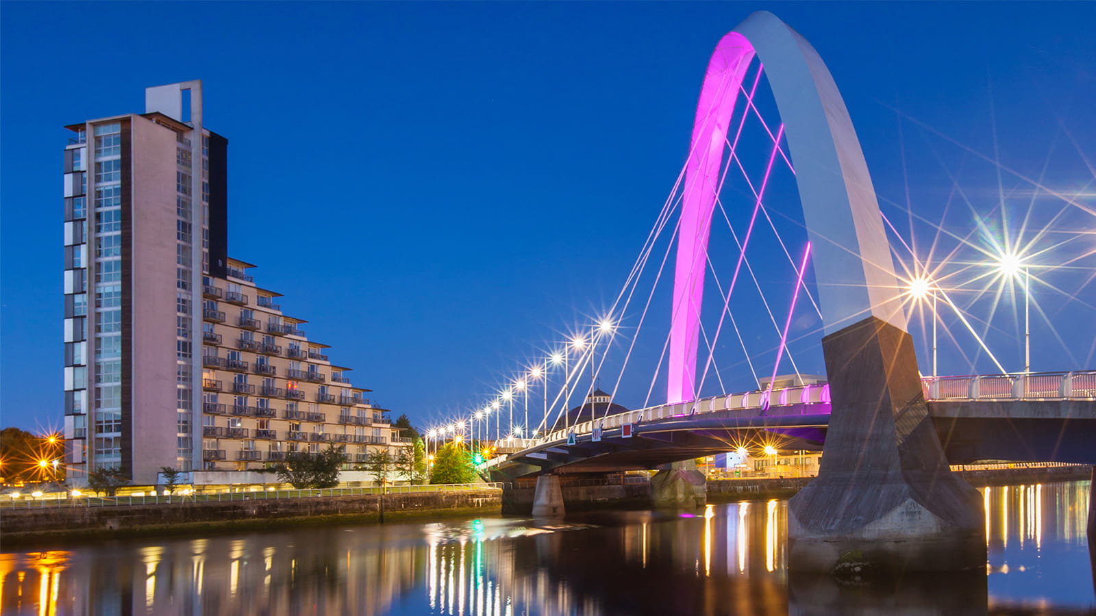 The Clyde Arc, Glasgow, Scotland, bridge arch city apartment building night lights