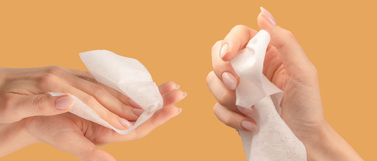 hand holding cleaning with wet water wipes orange background