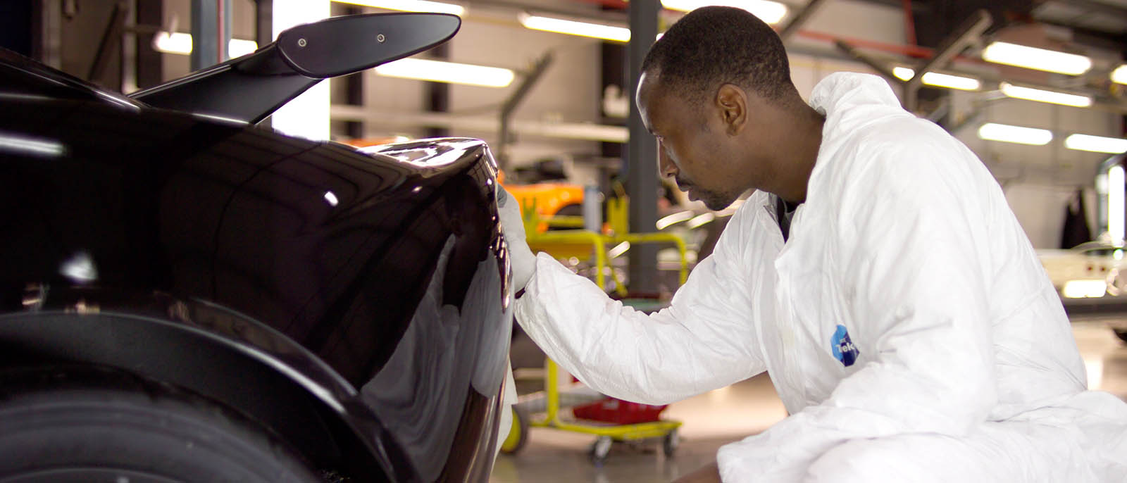 Production line at Lotus Cars Norfolk UK engineer working on car