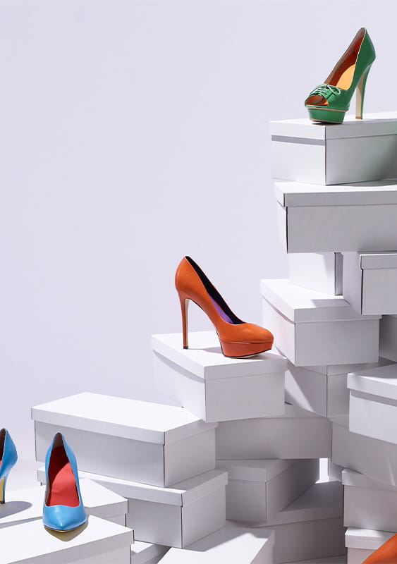 Various high heel womens shoes piled on shoe boxes