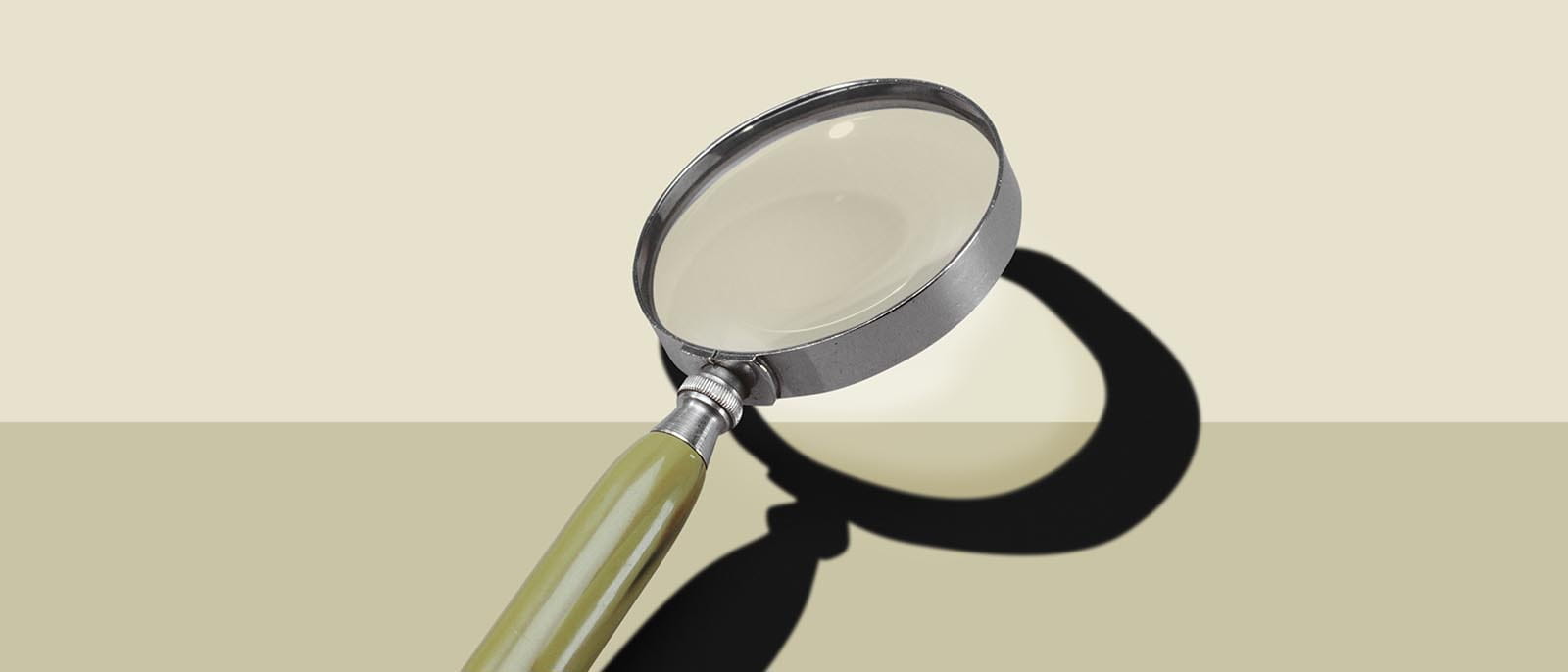 magnifying glass on a beige background