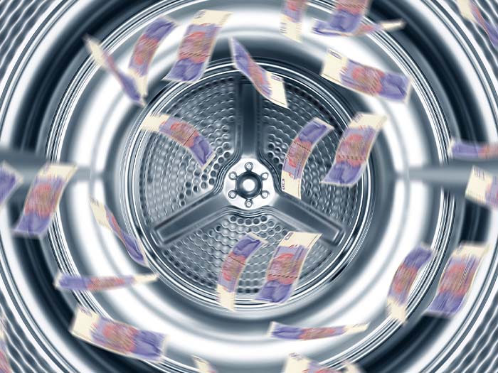 inside of washing machine drum with money cash notes spinning around