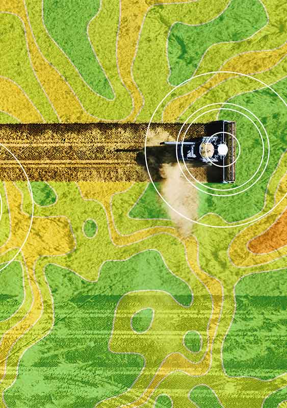 aerial photo of farming machinery ploughing land with a topical pattern