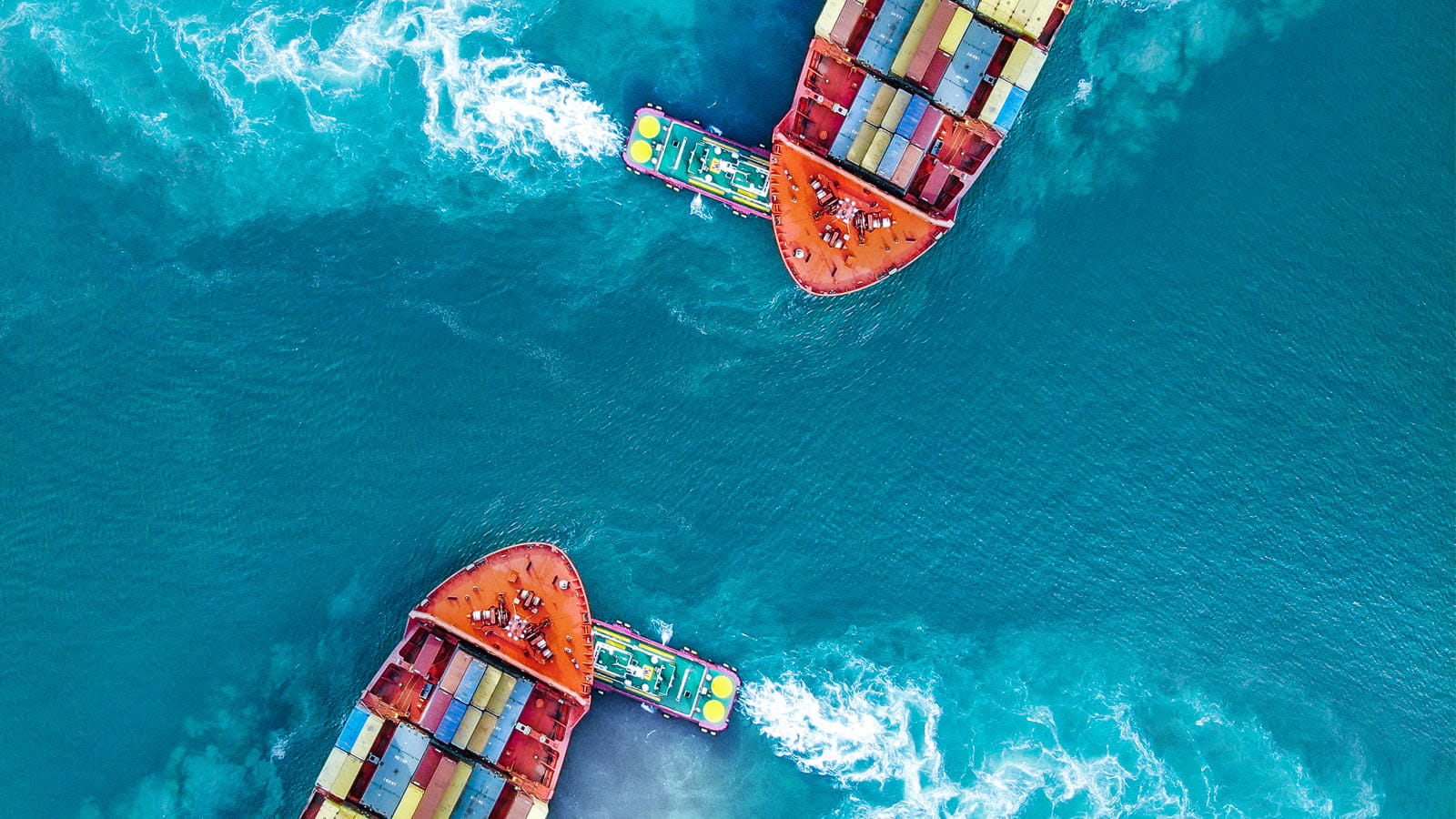 aerial photo of two large cargo ships on the ocean shipping containers water sea
